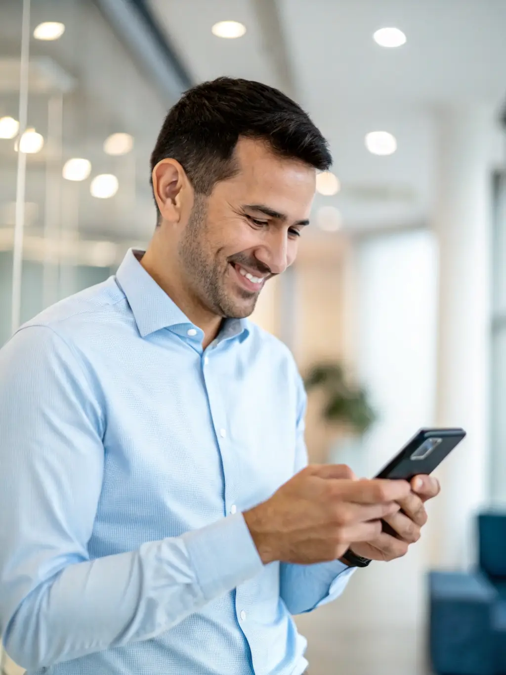 An image of a person confidently making an online loan payment via a mobile device.